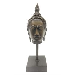 Bronze Buddha head upon a square marble base, H20cm