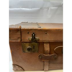 Early 20th century leather trunk, with brass fixtures, leather straps and buckle fastenings, embossed to the top with initials GG, H28cm, W76cm