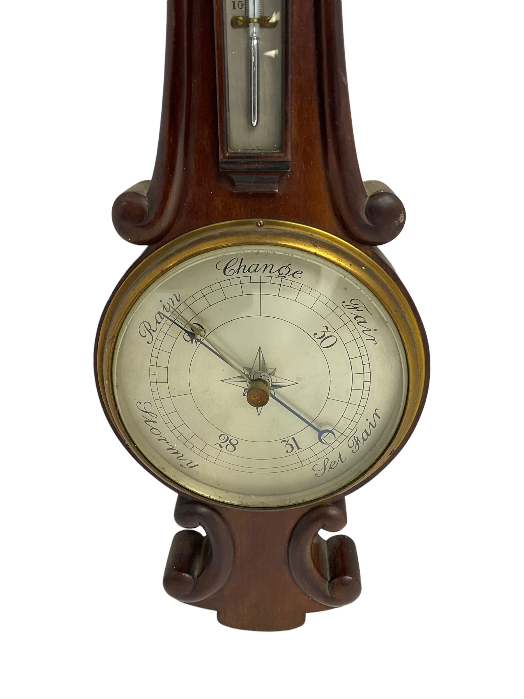Early 20th century aneroid barometer c1910 in a scroll carved mahogany case with a silvered dial