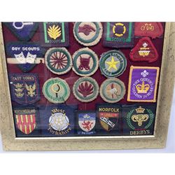 Boy Scout Interest; framed collection of Boy Scouts cloth insignias, to include badges from East Yorkshire, Northumberland, West Yorkshire, Devon, Norfolk and Derby, thirty four badges in total  
