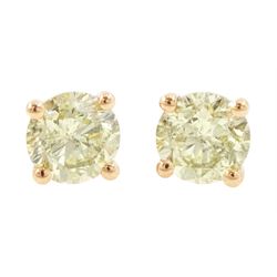 Pair of 18ct rose gold fancy yellow diamond earrings, each stud four claw set with a round...