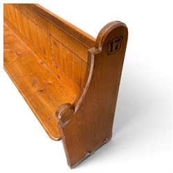 Early 20th century stained pine ecclesiastical church pew, the shaped end supports flanking slatted and panelled back, with black stencilled number '17' to the side