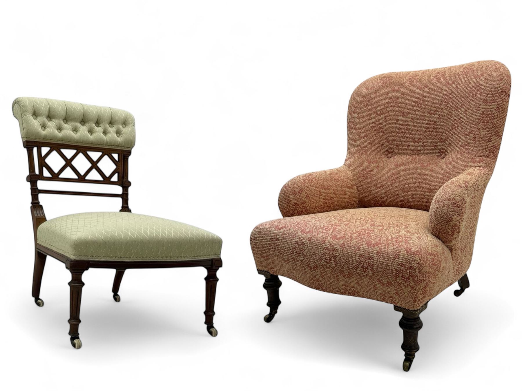 Late Victorian upholstered armchair, with high camel back and deep seat, padded arms and backrest in crimson and cream damask-style fabric, raised on turned ebonised front supports with ceramic castors (H88cm, W65cm, D 60m); and an Edwardian bedroom chair with button upholstered rail back (H72cm, D64cm, W53cm) (2)