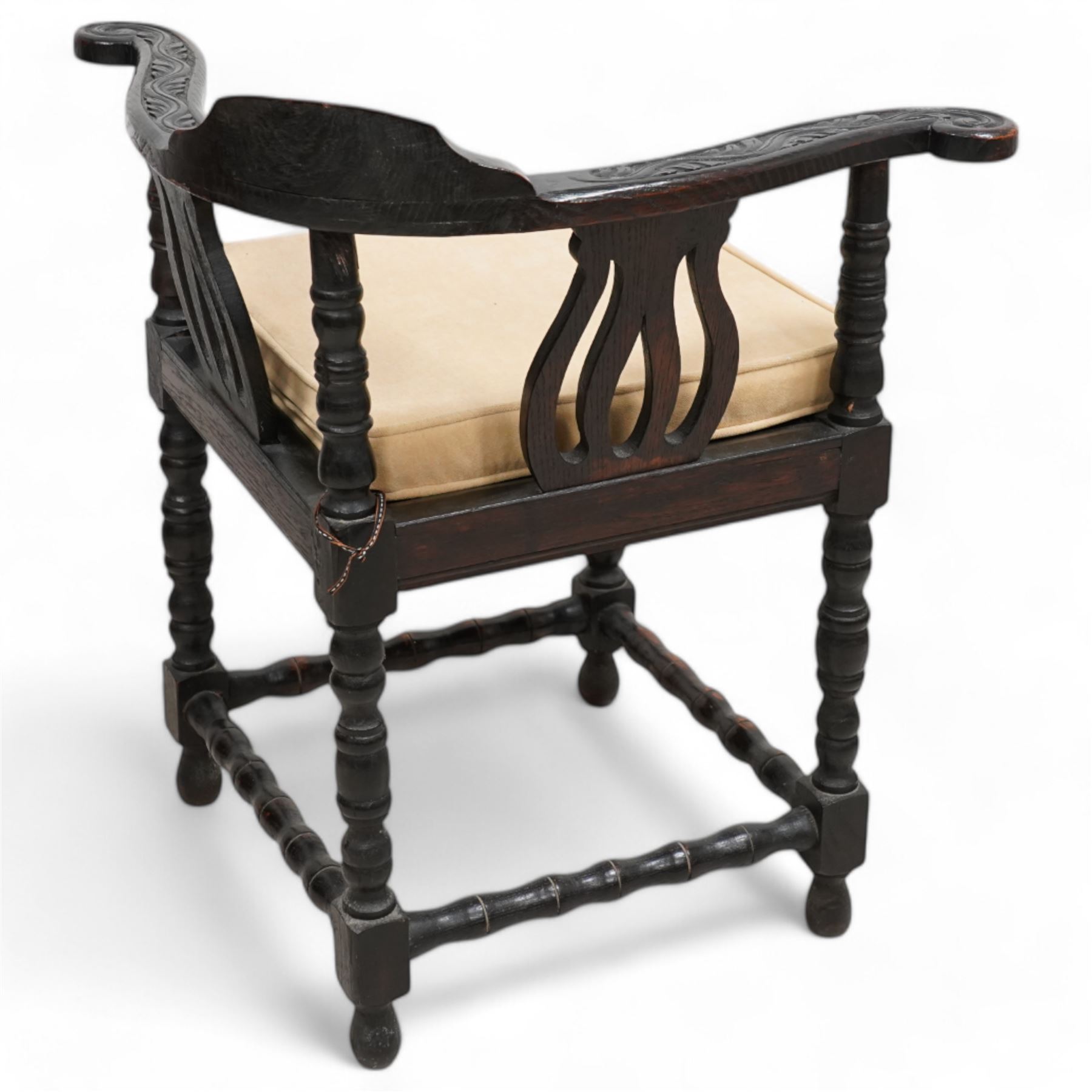 Victorian carved oak corner chair, shaped arms carved with trailing leafy branches, pierced splats over panelled seat, on bobbin turned supports and stretcher