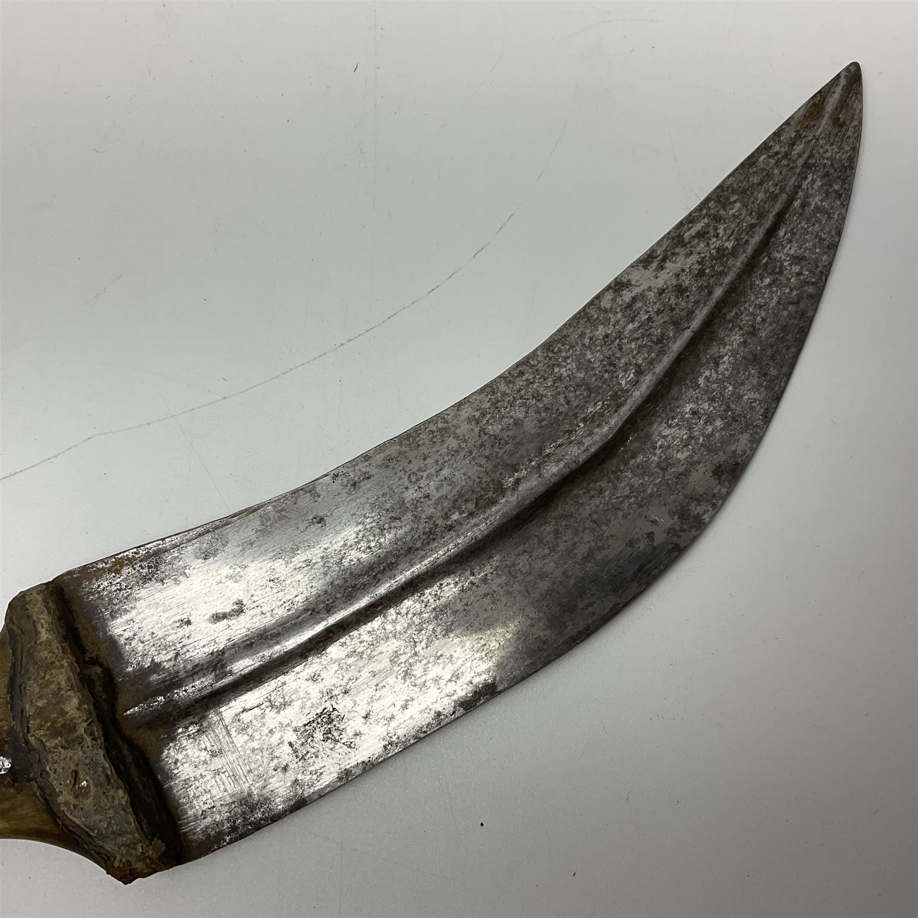 Late 19th century Yemeni Tuza jambiya as worn by religious elite, the 20.5cm curving blade with raised medial ridge, the horn hilt with pique style studwork, in a leather wrapped wooden scabbard with pierced metal mount and leather belt applied with embroidered 'gold' and 'silver' thread work panel; dagger L36cm overall, belt L84cm