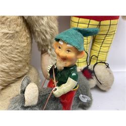 Deans Rag Book Mickey Mouse soft toy, circa 1930's, black velveteen head and body, with cream face and hands, red shorts and yellow felt shoes with leather soles, marked Reg. No. 750811 to neck H20cm; mid-20th century woodwool filled plush covered teddy bear with revolving head, applied eyes, vertically stitched nose and mouth and jointed limbs H52cm; soft toy figure of Rupert Bear; and Japanese clockwork tin-plate and plush covered mechanical toy of a gnome riding a donkey (4)