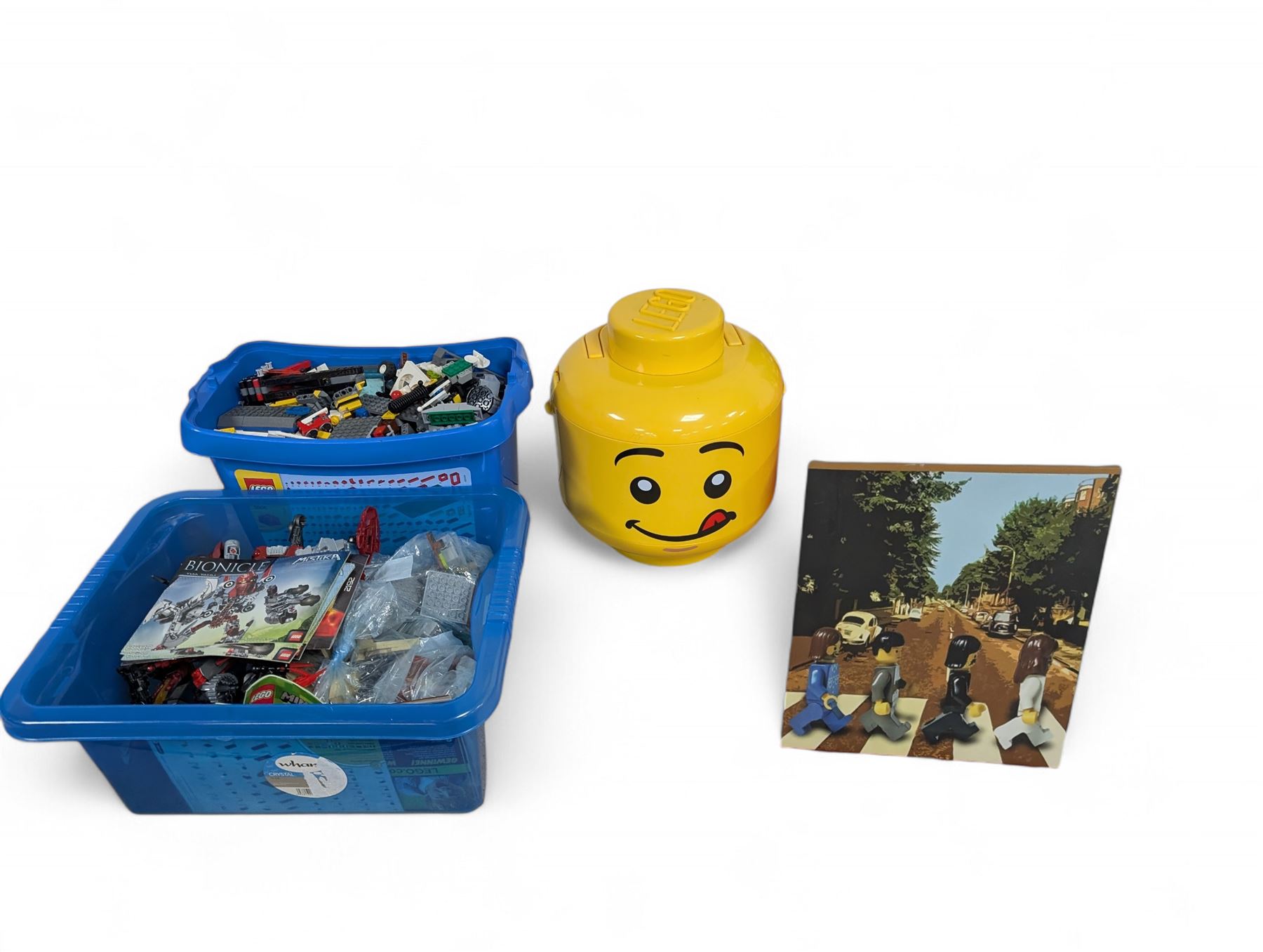 Collection of Lego, including built Bionicles Mistika models with instructions, loose Lego pieces, Lego Beatles Abbey Road canvas print and a Lego head storage box