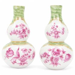 Pair of small late 19th century German double gourd vases, probably Dresden, each hand painted in puce with reserves of a courting couple within a garden setting, and floral sprays upon a white ground, within a green painterly surround, each with very faint traces of blue marks to the unglazed base, H12.5cm
