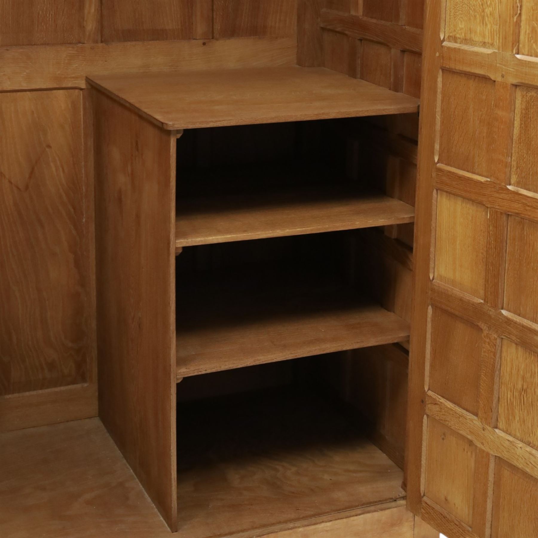Mouseman - early-to-mid-20th century panelled and adzed double wardrobe, the arcade carved cresting rail over two panelled doors, with wrought metal hinges and latch, deep relief carved mouse signature, the interior fitted with hanging rail, by the workshop of Robert Thompson of Kilburn