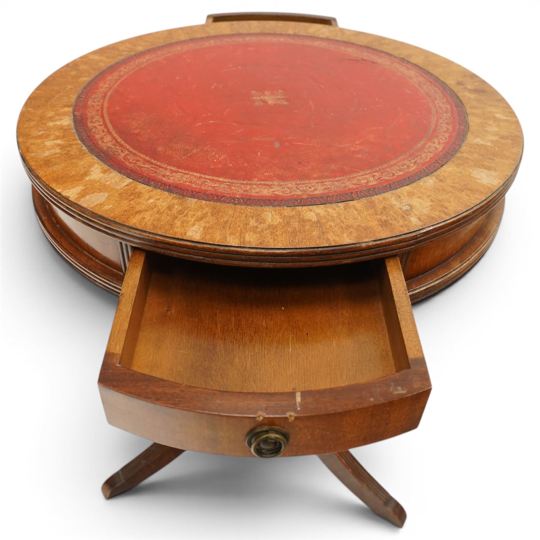 Regency style mahogany drum table, circular red leather inset top with gilt and blind tooling, bird's-eye maple crossbanded border, fitted with two opposing pull-out slides, on turned pedestal and three outswept support