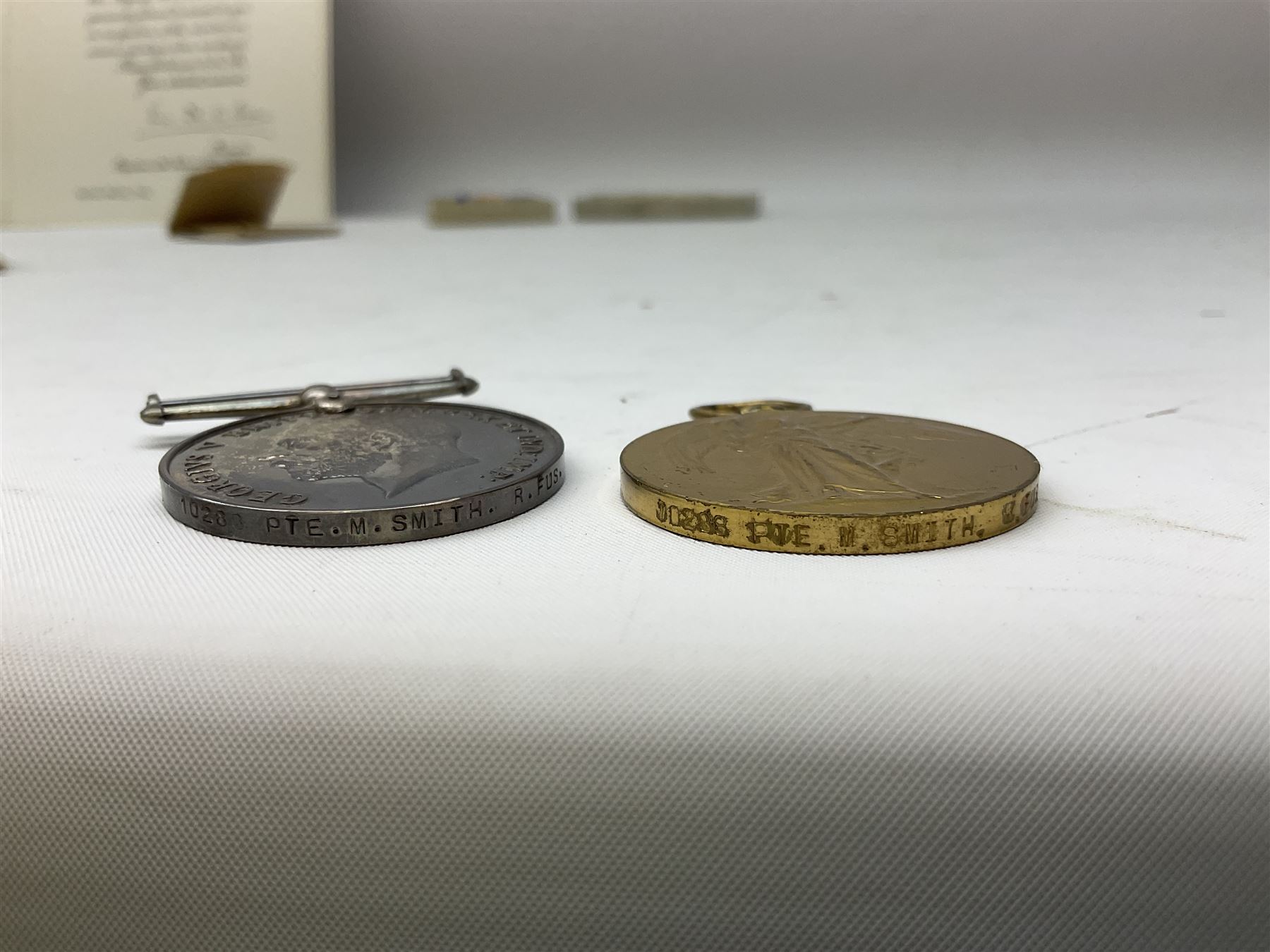 WW1 group of three medals comprising British War Medal and Victory Medal in issue box and Ceylon Volunteer Service Medal awarded to 10288 Pte. M. Smith R. Fus.; together with a later awarded WW2 Defence Medal in modern box with slip; and his QEII Imperial Service Medal in case and box with certificate dated 1959