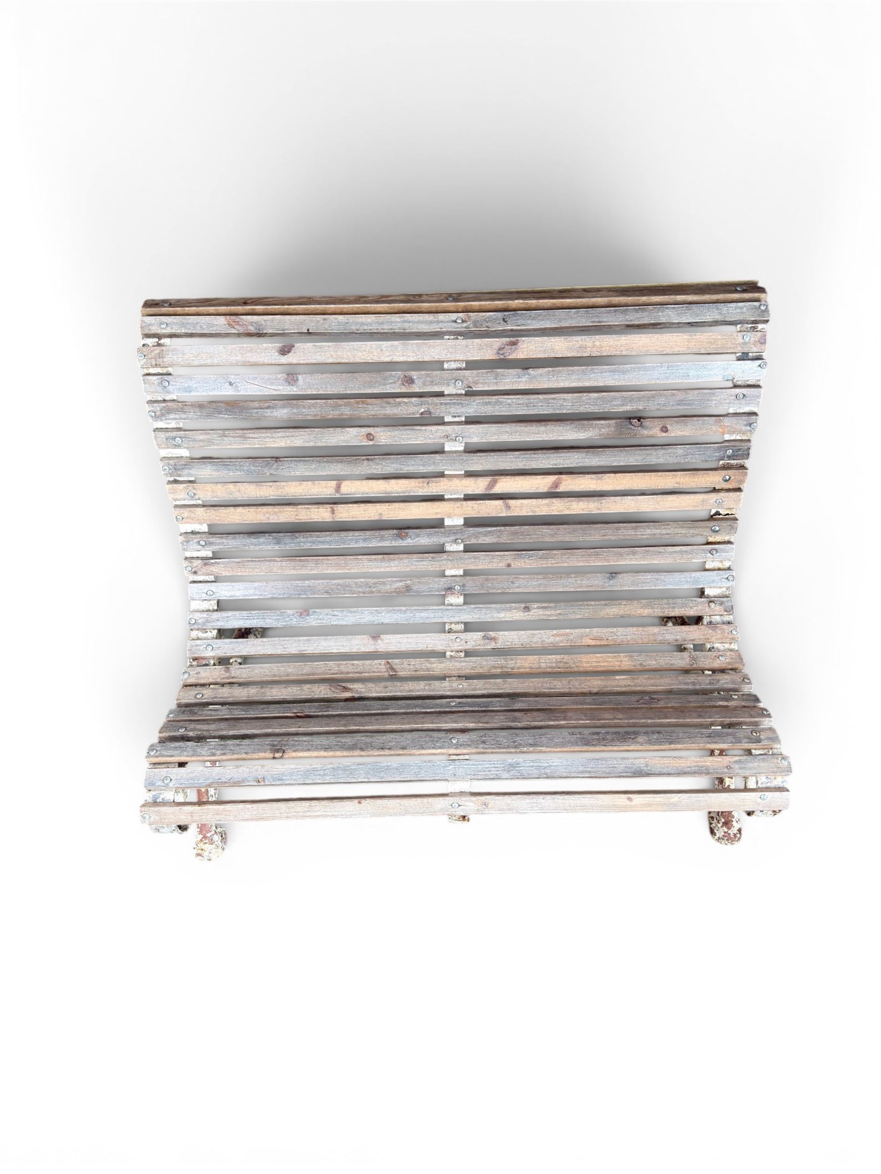 19th century cast iron and wood slatted garden bench, high scroll back form, low X shaped base, finished in distressed white paint