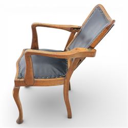 20th century oak recliner armchair, the curved back upholstered in leather with brass stud edging, hinged reclining back operated by side ratchet fittings, leather upholstered seat, shaped open arms, raised on cabriole legs