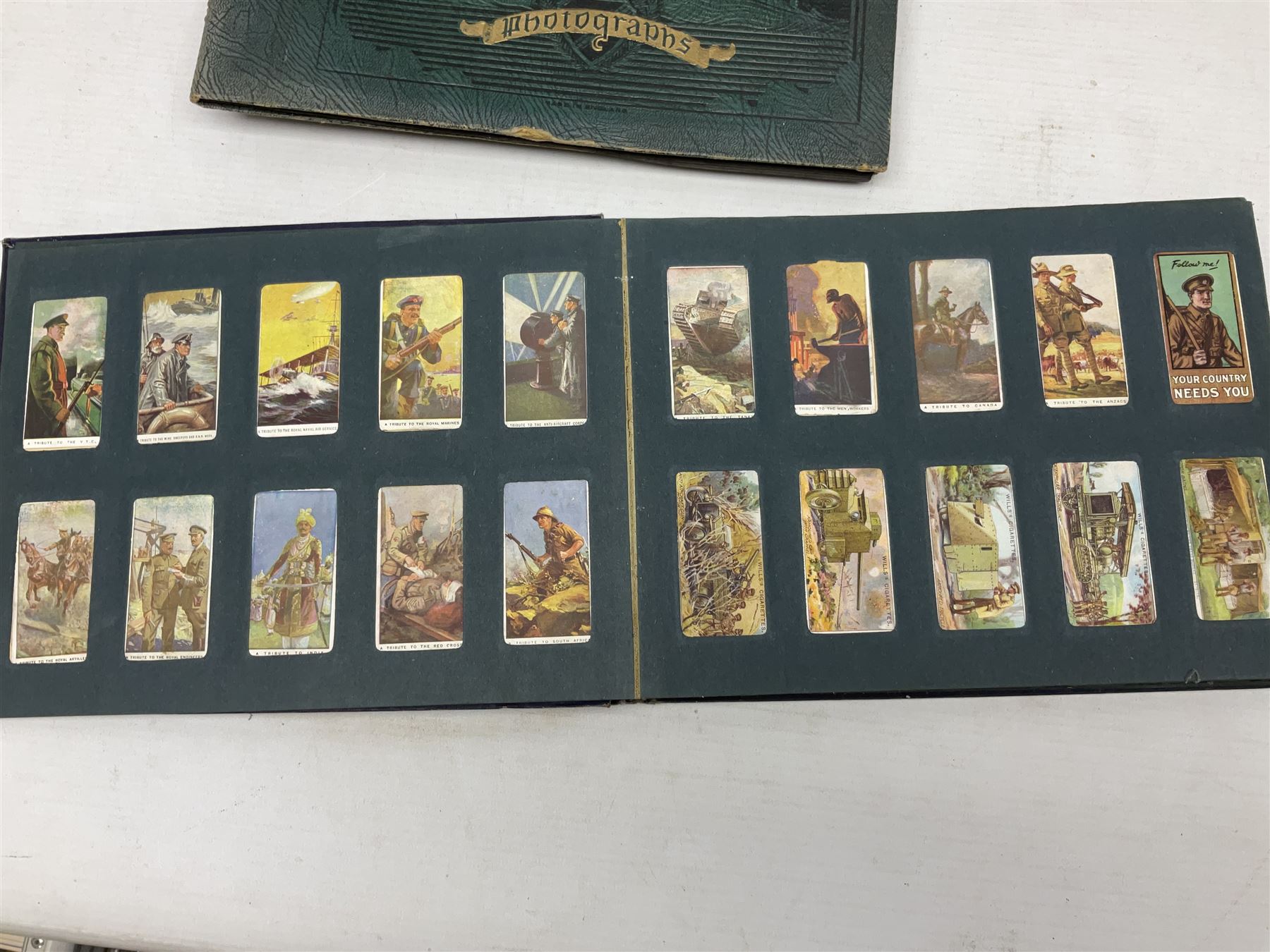 Three albums of cigarette cards including Wills Recruiting Posters, Military Motors and Allied Army Leaders, cricketers etc; another album containing a large quantity of laid-in cigarette cards; and an album of thirty-seven postcards of dogs by Mac (5)