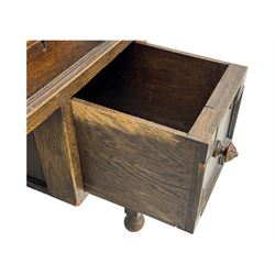 Early 20th century Jacobean design oak desk, with rectangular top inset with worn tooled leather, two frieze drawers over pedestals each fitted with a pair of panelled drawers, turned handles, on carved and fluted tapering legs united by stretchers 