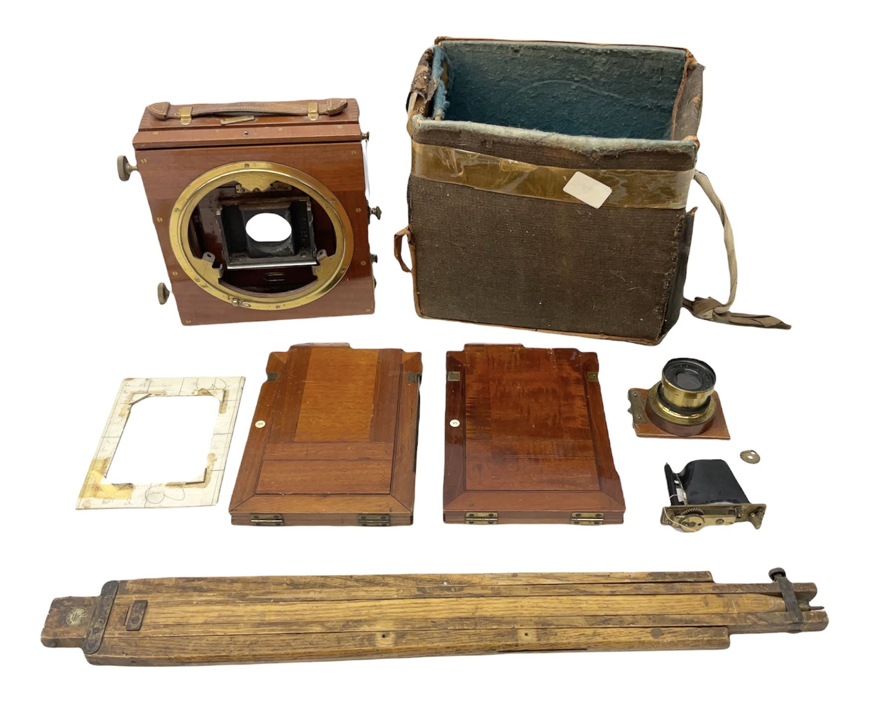 Ensign 'The Sanderson' folding plate camera in mahogany and lacquered brass, field model with canvas wrapped box, two mahogany photographic plates, 'Busch rapid Symmetrical F:8' lens,  and a wooden tripod 