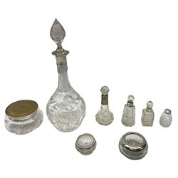 Glass decanter with silver collar and glass stopper, hallmarked John Grinsell & Sons Birmingham date mark worn and indistinct, a glass bowl with a metal and silver lid, hallmark London, maker and date mark worn and indistinct, together with four scent bottles with silver collars, hallmarked and two glass bowls with mounted silver rims, hallmarked