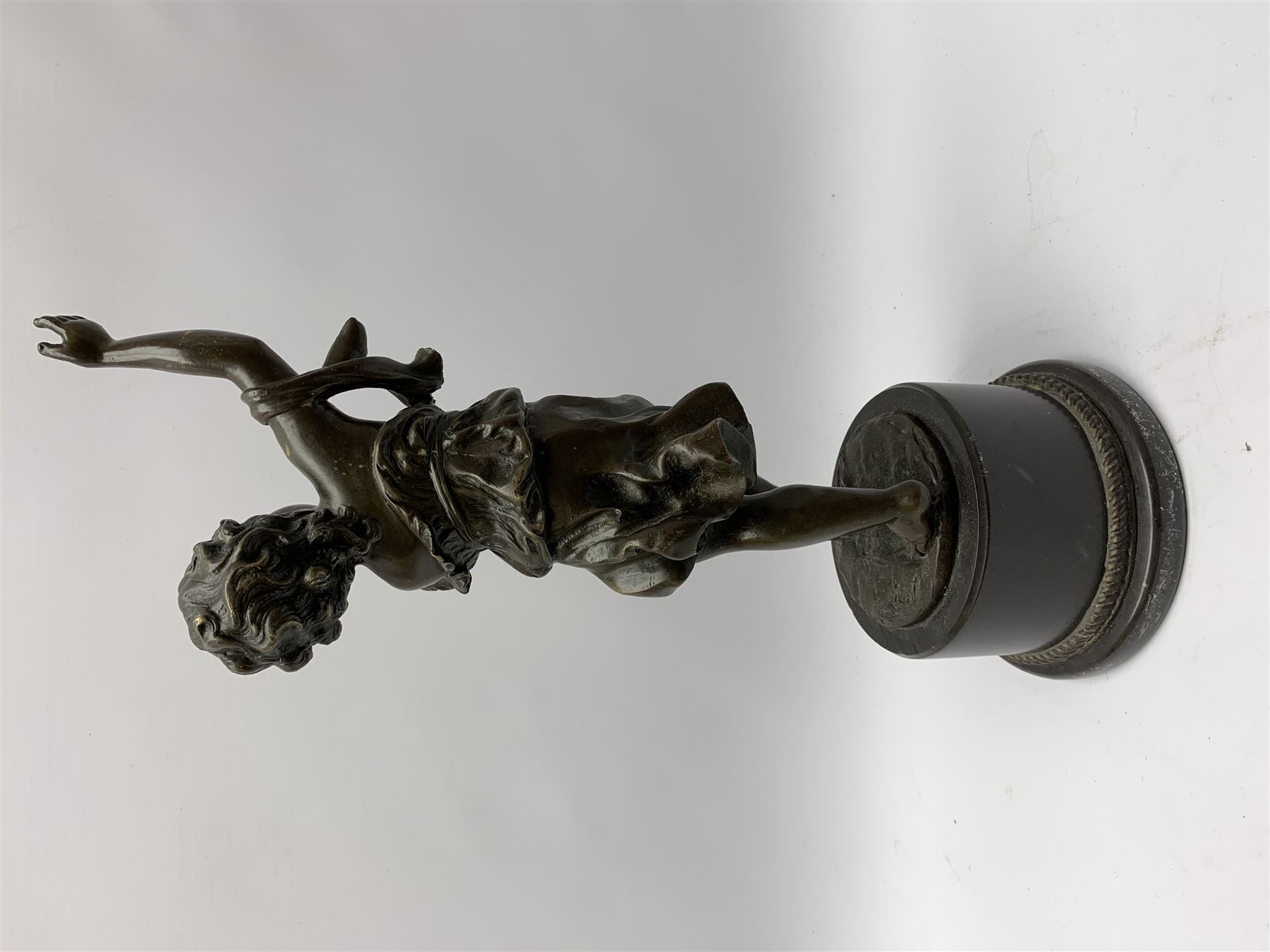 After E Plat, bronze modelled as a dancing child, signed E. Plat, upon cylindrical black marble base, H40cm