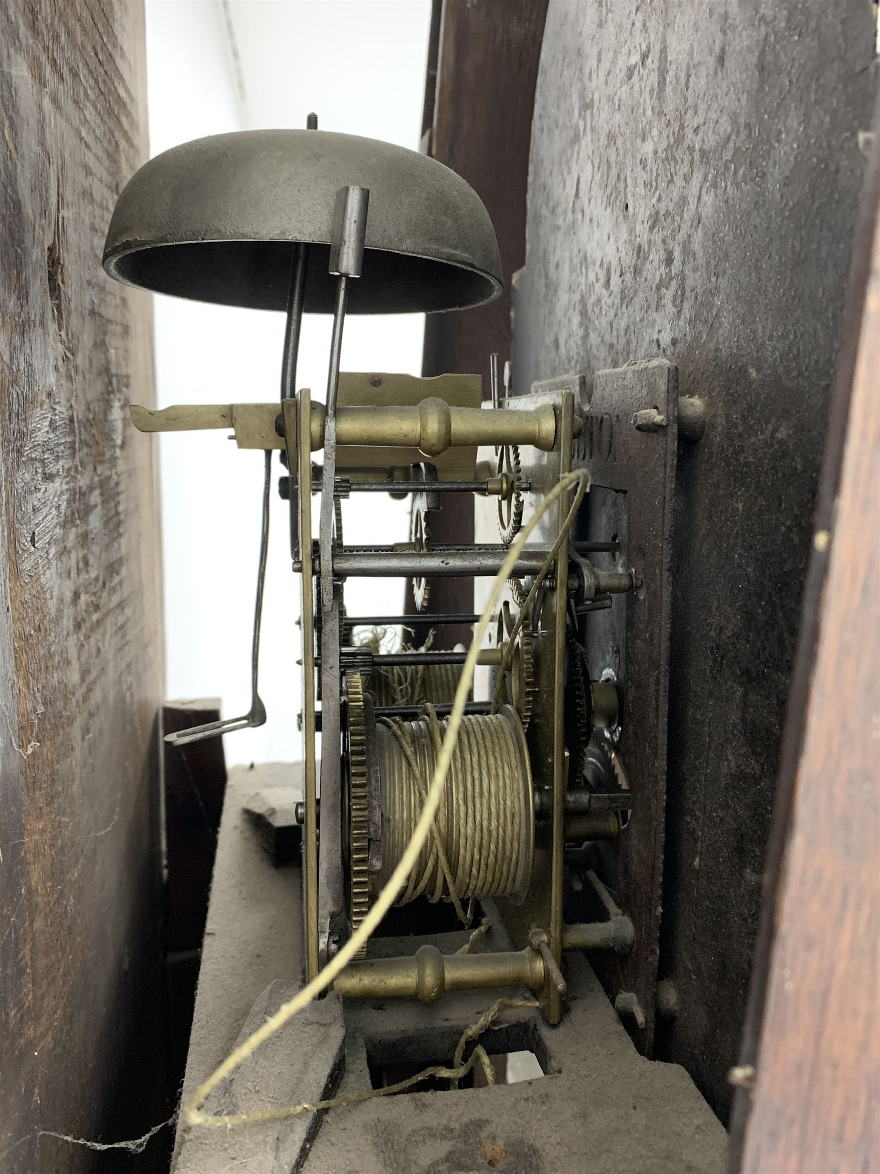 Early 19th century oak longcase clock, shaped pediment over a stepped arch glazed door enclosed by plain pilasters, the case with canted corners and trunk door with sloped arch top and centre curved return, enamel Arabic dial painted with flowers and patterned spandrels, signed 'Jno. Hilbert, Haxby', eight-day movement with subsidiary seconds dial and false calendar dial 