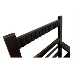 Late Victorian oak steamer chair, adjustable slatted backrest with grooved crest rail, wide armrests extending to a sliding adjustable footrest, open frame sides with vertical slats, side magazine rack and collapsible table, raised on turned front supports