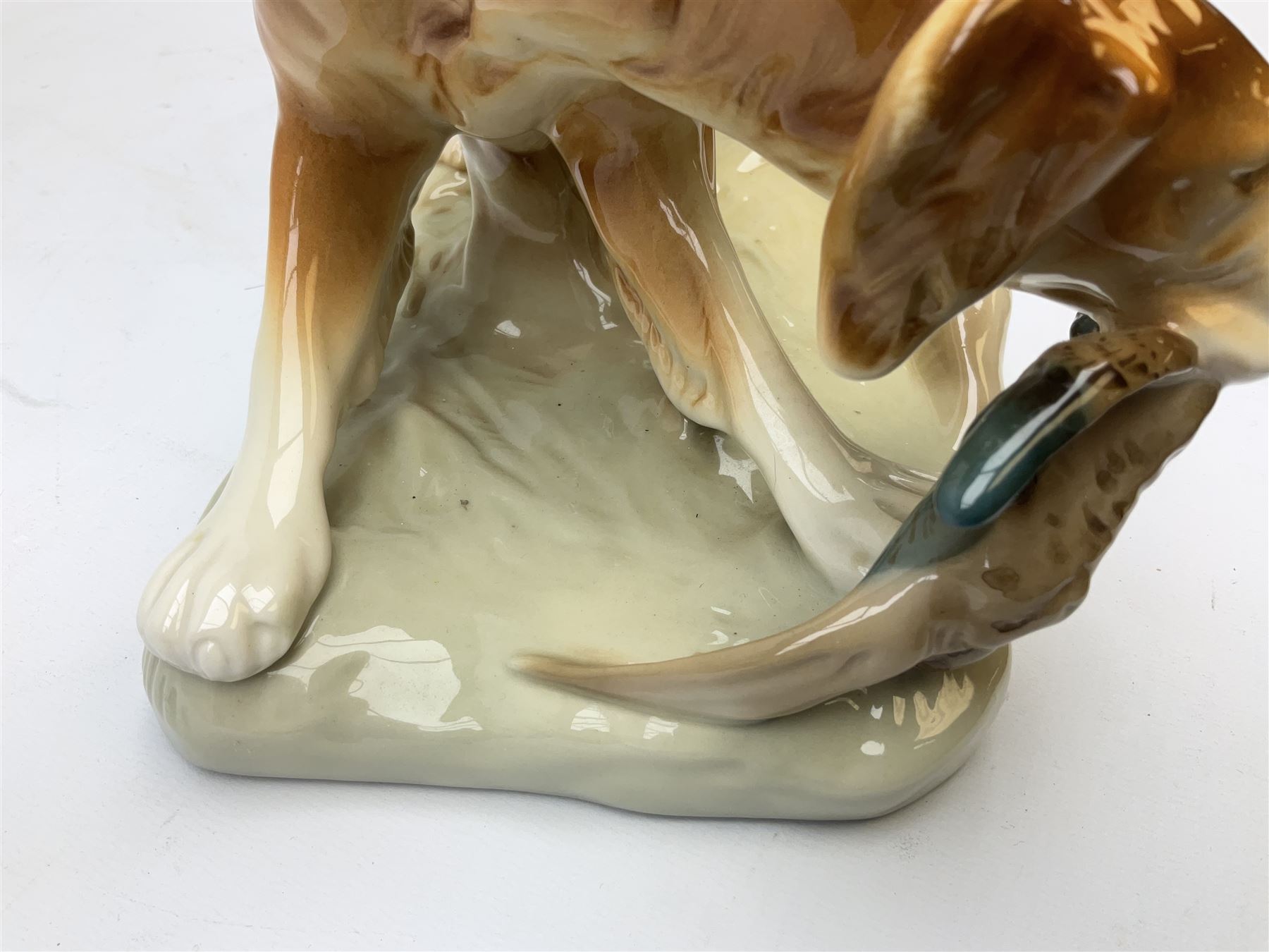 Royal Dux porcelain hunting dog with a bird, printed mark beneath, L36cm