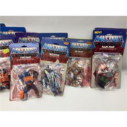 Thirty-one Masters of the Universe He-Man figures re-bagged on original backing cards;  two others lacking backing cards; boxed Modulok figure; bag of weapons and accessories; Roton, two horses and two battle cats; 1986 & 1987 Annuals; Ladybird and other story books; Panini sticker album; instructions etc
