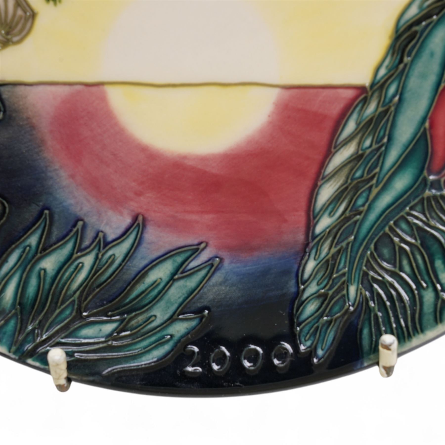 Moorcroft limited edition Birth of Light pattern millennium year plate, numbered 699/2000, impressed and painted marks to base; together with three other year plates comprising 1998, 1992 and Spitalfields Temple Mills edition 1991 plate (4)