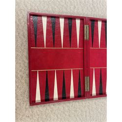 19th century walnut and brass bound games compendium box, painted to enhance the grain, of rectangular form, the hinged opening cover with rounded sides, central brass cartouche with engraved lion crest, and brass riveted straps, opening to reveal a red leather and blue silk lined compartmented interior, with fold-down games board, and lift-out tray containing playing cards, ebony turned dice towers, white and red stained bone draughts, and chess pieces, ivory dice, and ivory and ebony whist markers, and brass bezique board, cribbage board and markers, H15cm W32cm D24cm
This lot has been registered for sale under Section 10 of the APHA Ivory Act