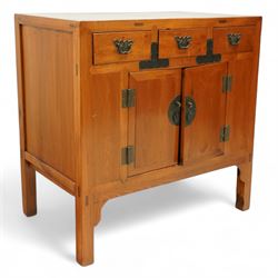 Mid-20th-century Chinese elm side cabinet, rectangular top above three drawers and a pair of panelled cupboard doors, mounted with traditional brass butterfly form handles and pierced circular lock plate 