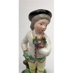 A 19th century Höchst porcelain figure, modelled as a young boy holding a Garland of flowers, H14cm, (a/f, restoration to hat and legs and base). 