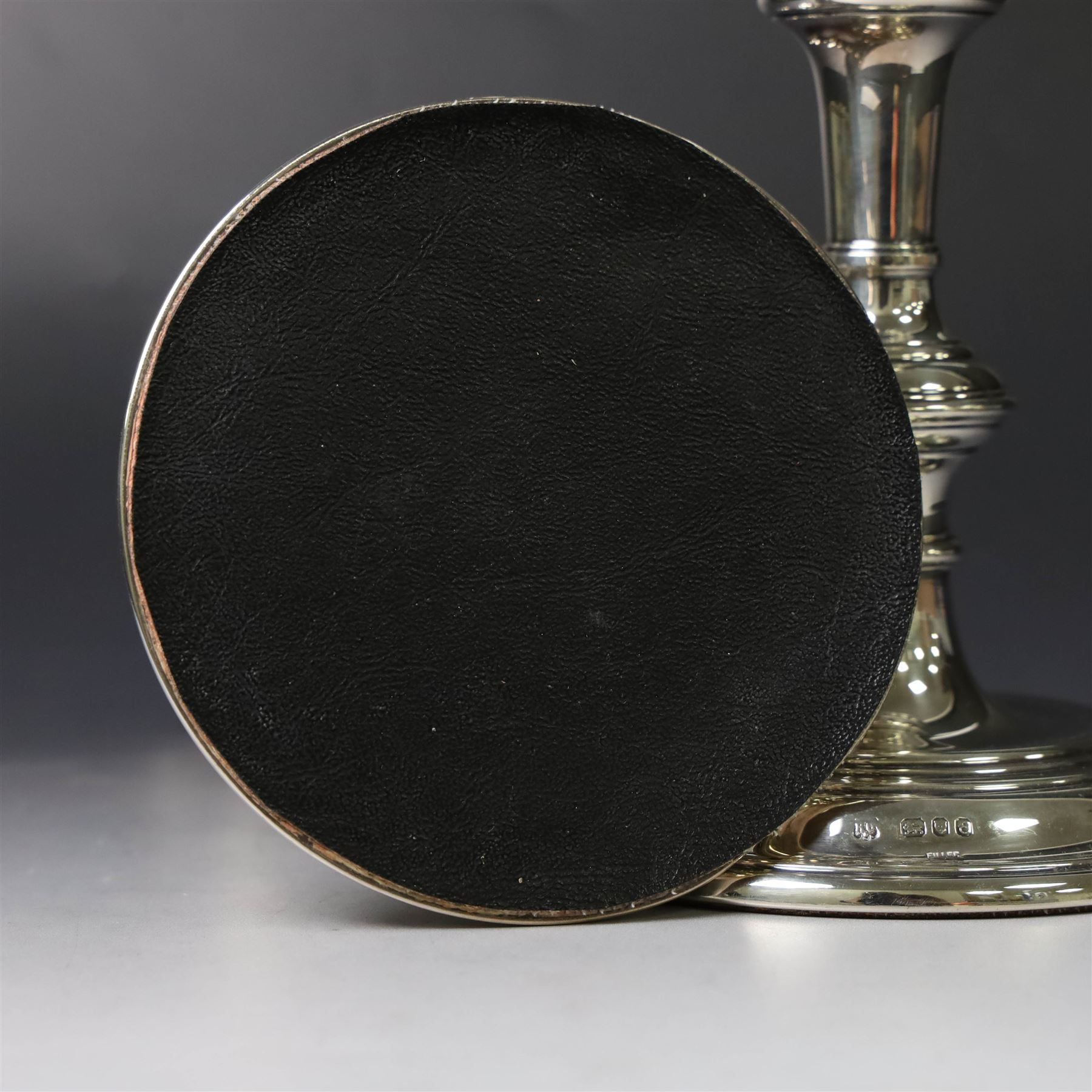 Pair of silver candlesticks, with knopped stems and upon spreading circular weighted bases, hallmarked William Comyns & Sons Ltd, London 1979, H20cm