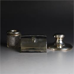 Edwardian silver fall-front ring box with loop handle, opening to reveal velvet interior with five ring spaces, hallmarked Deakin & Francis, Birmingham 1907, together with a cut glass jar with silver lid inscribed 'Hair Tidy' and a silver mounted capstan inkwell, both hallmarked 