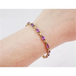 9ct gold amethyst and diamond bracelet, fifteen oval cut amethysts each spaced by two diamond chips in a crossover marquise setting, hallmarked