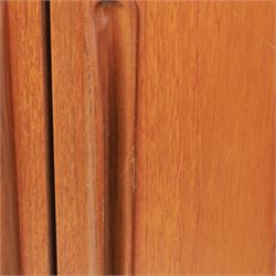 G Plan - 'Fresco' teak double wardrobe, twin doors enclosing a single clothes rail, on a recessed plinth base with castors beneath  