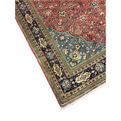 Persian Sarouk rug, red and blue ground, the field decorated with scrolling foliate and stylised plant motifs, the border decorated with floral panels