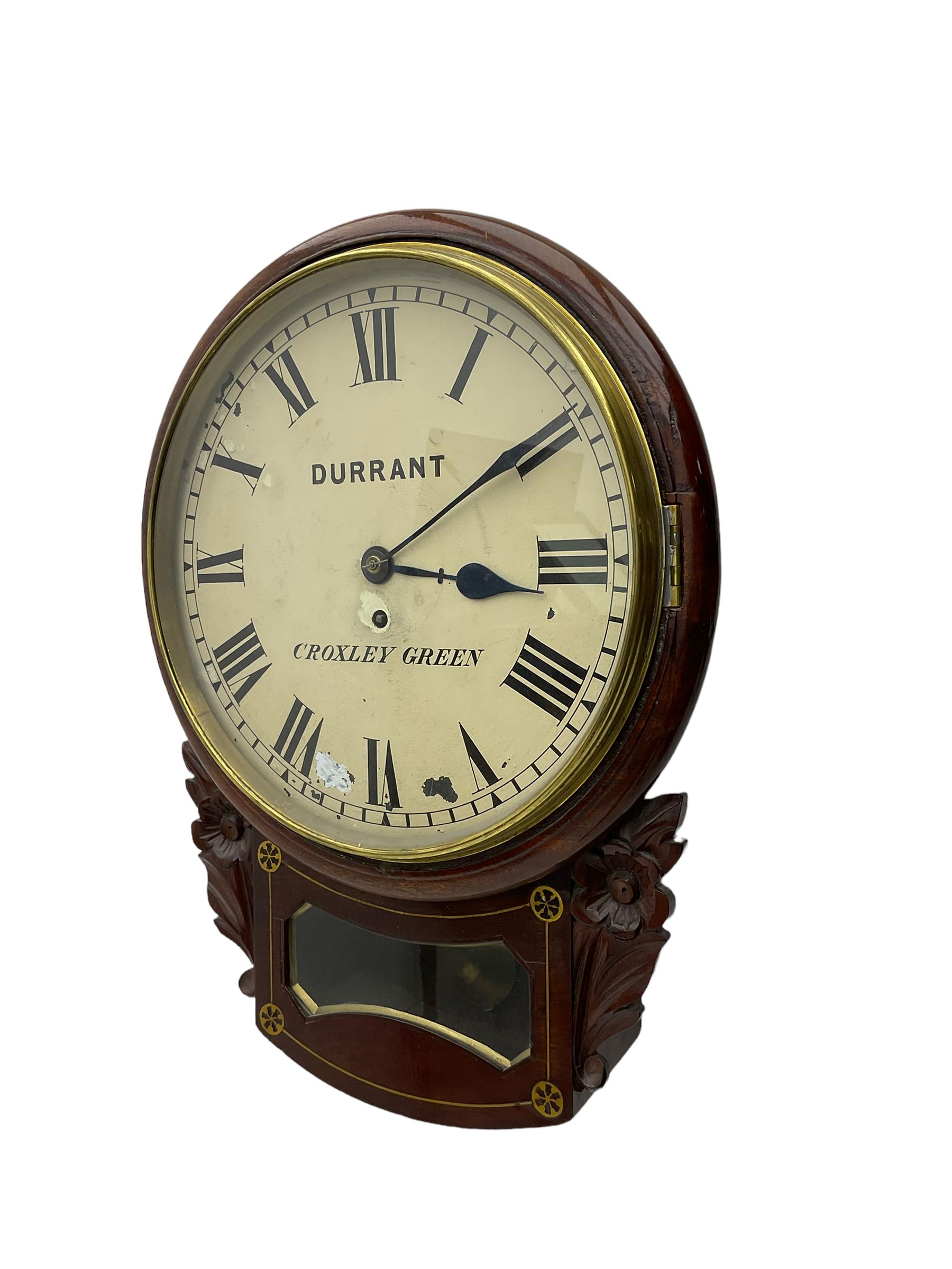 A late 19th century drop dial fusee wall clock in a mahogany case with brass inlay and a carved representation of flowers flanking the glazed pendulum viewing glass, with case side door and pendulum adjustment door, 12