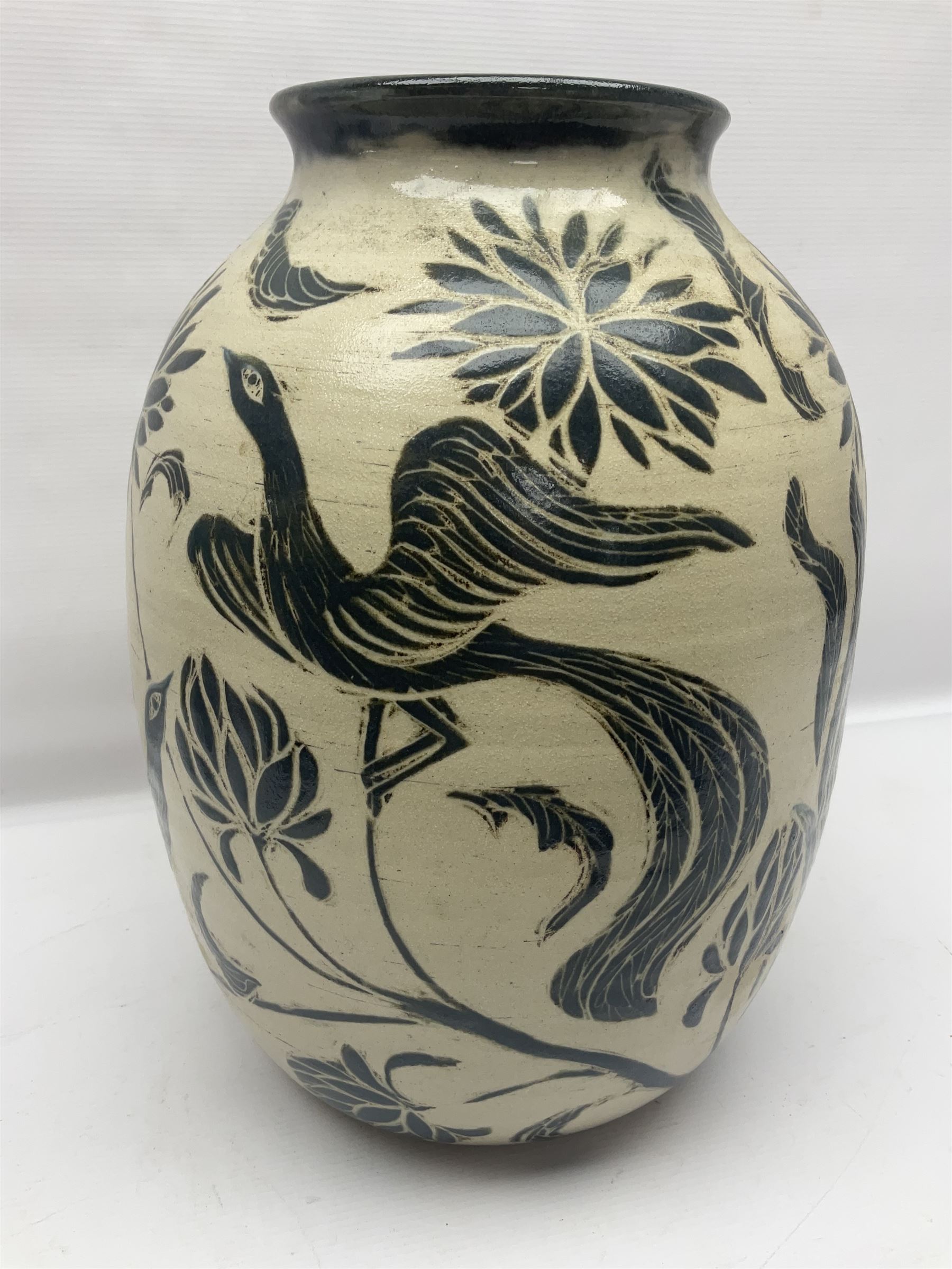 John Egerton (c1945-): studio pottery stoneware vase decorated with birds in flowers braches upon a white ground, H40cm