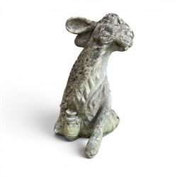 Two weathered cast stone garden hares