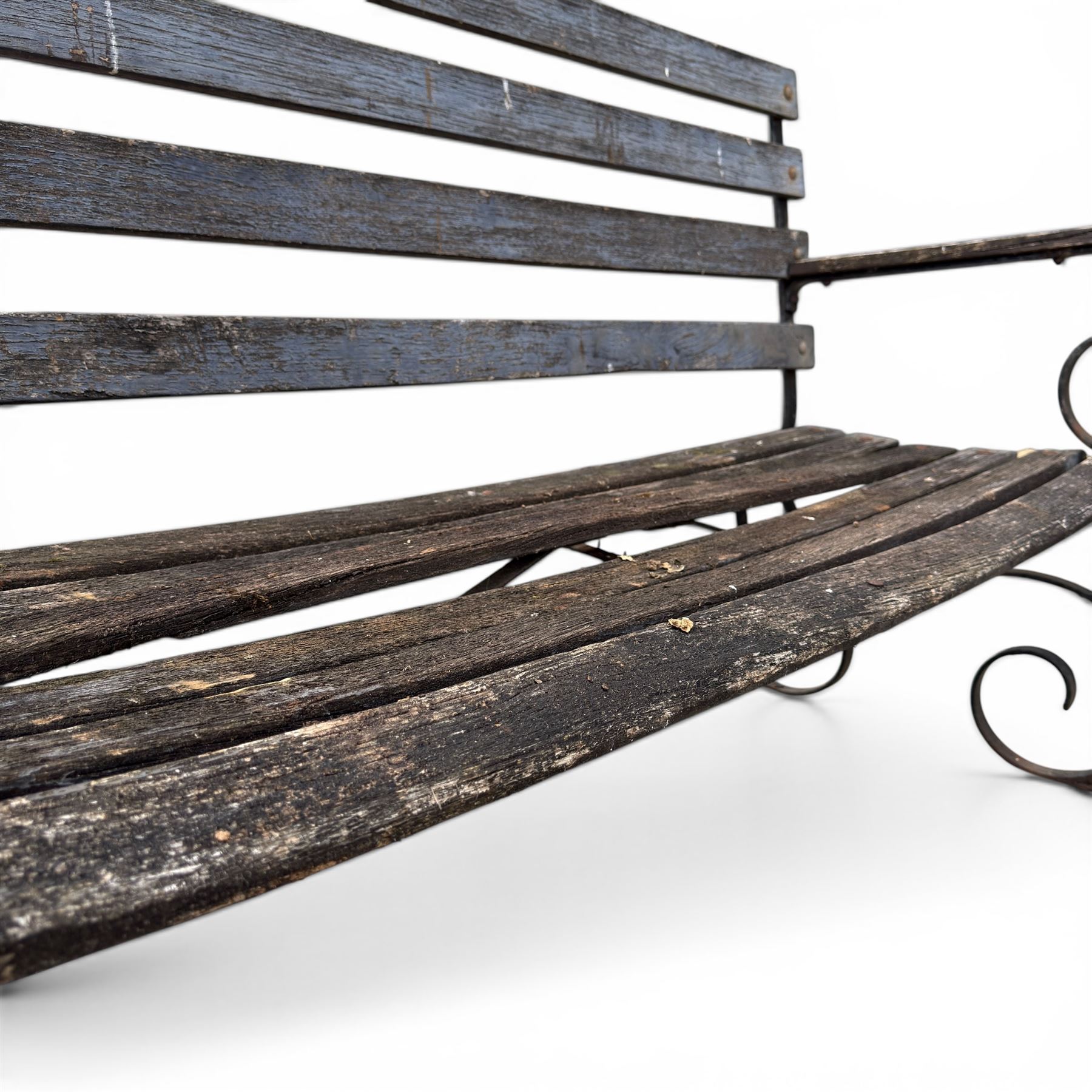 19th century wrought iron strapwork and slatted wood garden bench, the arm terminals and end supports of scrolling form