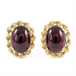 Pair of 9ct gold cabochon garnet stud earrings, stamped