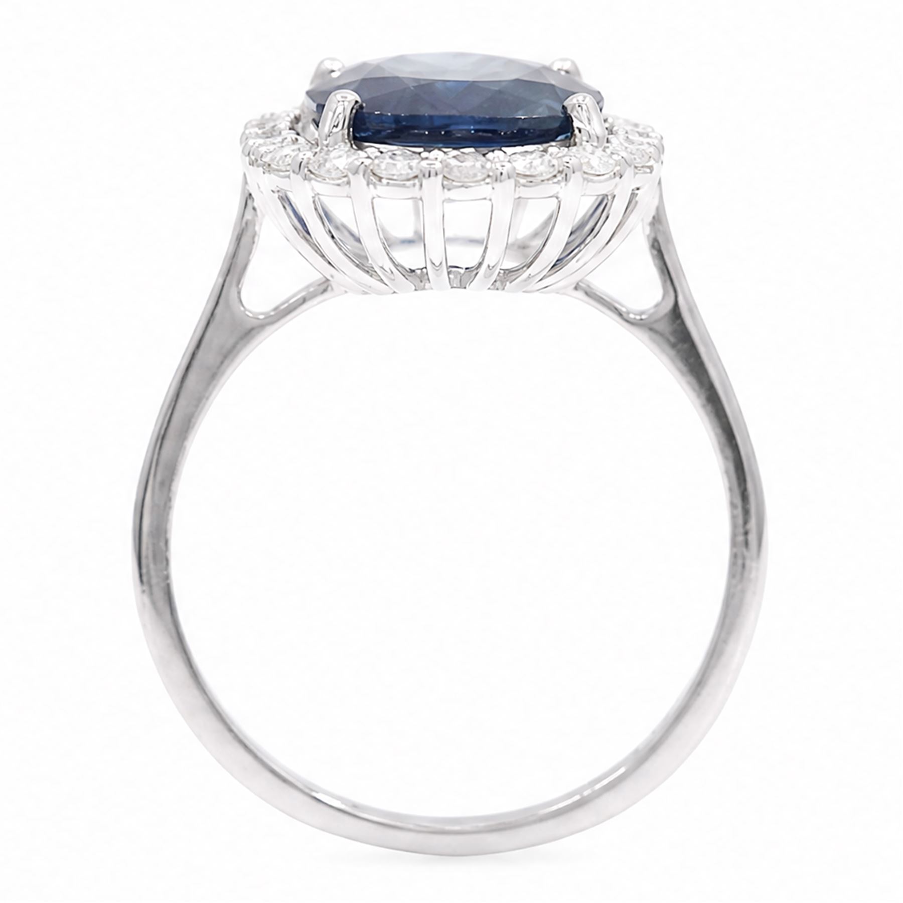 18ct white gold sapphire and diamond cluster ring, single cushion cut sapphire of approx 4.20 carat, surrounded by twenty round brilliant cut diamonds, stamped 750, total diamond weight approx 0.50 carat