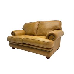 Two seat sofa (W160cm), and pair matching armchairs (W108cm), upholstered in a studded tan leather, with turned feet