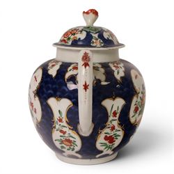 18th century Worcester teapot, circa 1763-70, of globular form, painted with shaped panels of chrysanthemums and banded hedges on a blue scale ground, cover with flower finial, mark beneath, H15cm