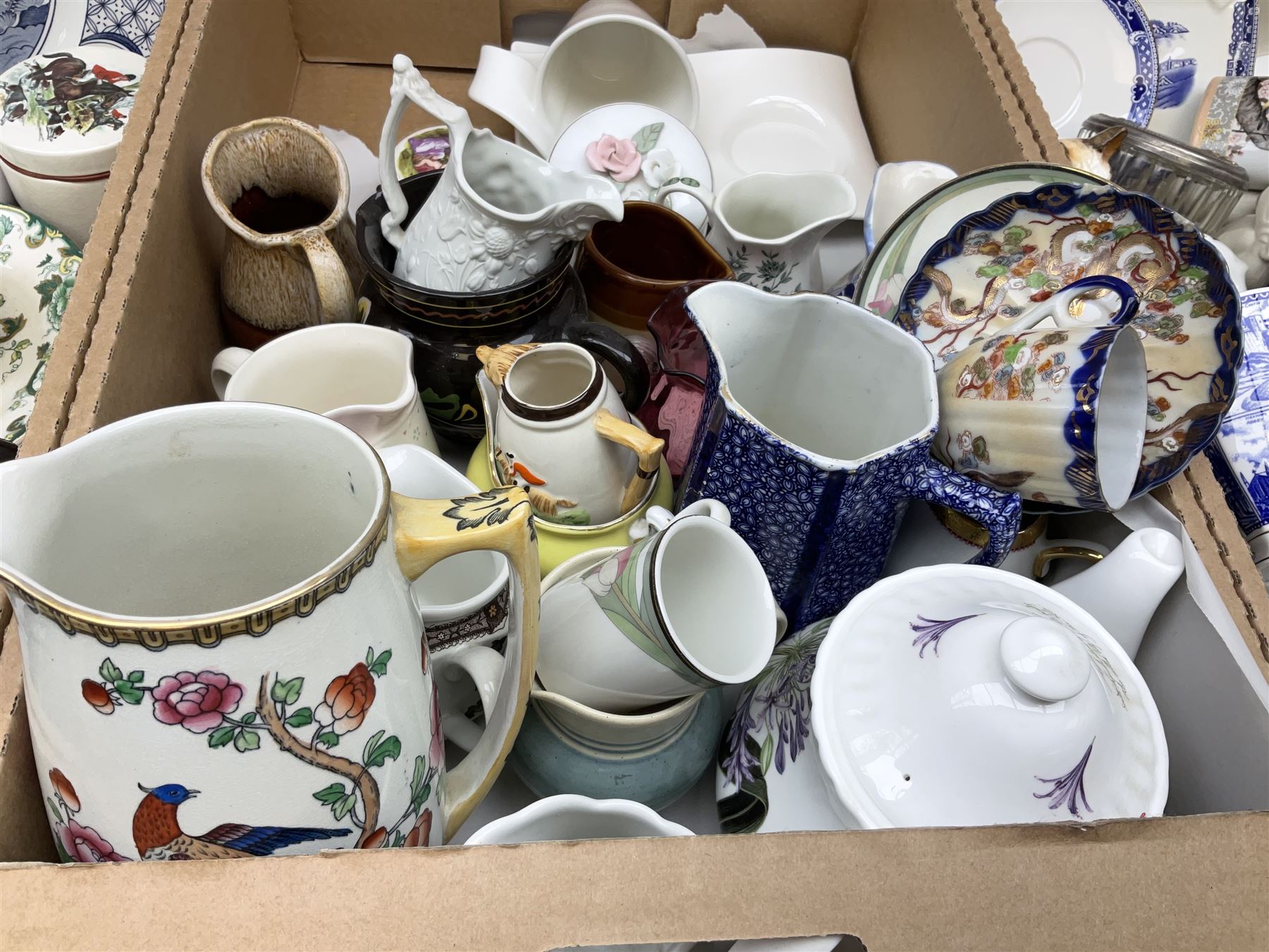 Quantity of various ceramics and glassware to include pair of Disney Mickey and Minnie Mouse cowboy Sherriff figures, stamped Japan beneath, Mason's ironstone, Wedgwood, Portmeirion, tea and dinner wares, collectors plates, glass animals etc in four boxes