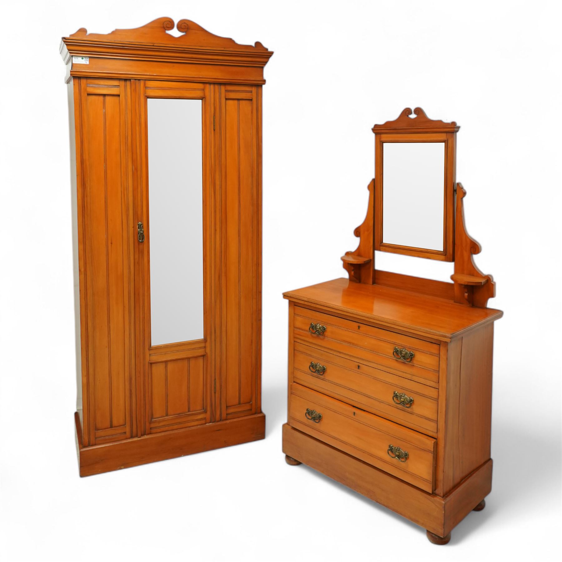 Early 20th century satin walnut wardrobe and dressing table, including a tall single wardrobe with mirrored door beneath a shaped cornice and moulded pediment, (H 205cm, D 39cm, W 91cm) and a matching dressing chest with glazed lift-top compartment and three drawers, mirror supported by scrolled uprights with flanking open shelves (H 170cm, D 45cm, W 84cm)