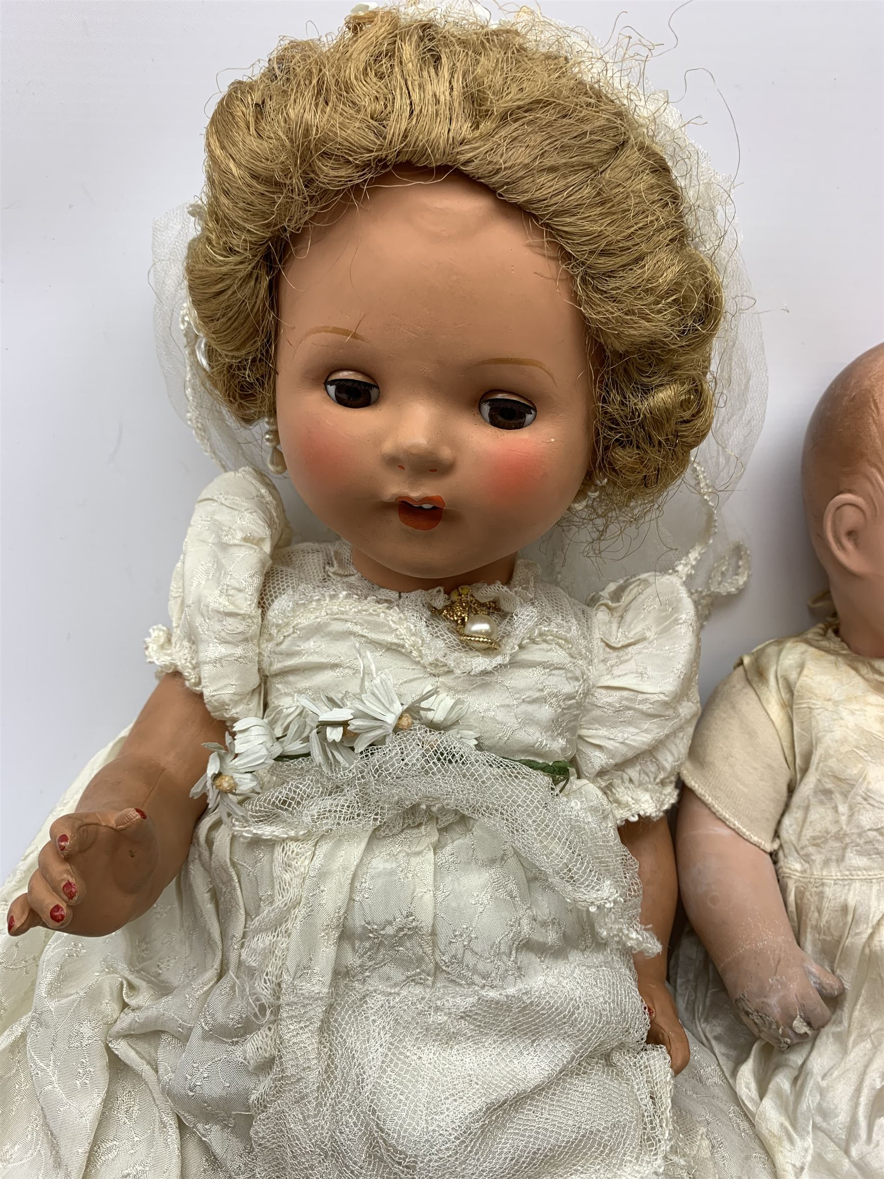 Seyfarth & Reinhardt composition head baby doll with moulded hair, sleeping flirty eyes, open mouth with one tooth and tongue and soft body with composition jointed limbs, marked 'SuR Germany 30/5' H47cm; together with a Golborne Dolls 'Golborne Beauty' composition head and body bride doll, marked 'F.P.23' in original box H63cm (2)