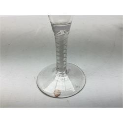 18th century drinking glass, the drawn funnel bowl upon a double series opaque twist stem and conical foot, H17cm, together with an 18th century dram glass, the bucket bowl crudely engraved with heraldic style shield, upon a knoped stem and folded circular foot, H9.5cm, a later blown and moulded glass water jug, and two open salts, one of navette form, (5)
