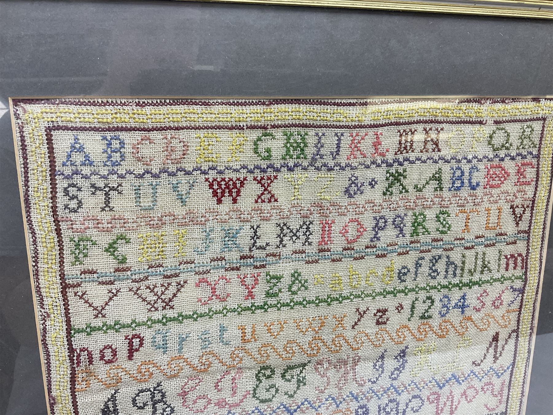 Victorian sampler, worked by Sarah Ann Duggleby, dated August 1864, depicting lines of alphabet, framed and glazed, by vendor repute Beswick Hall provenance, overall H46cm L43cm