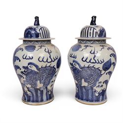 Pair of blue and white Chinese vase and cover, of baluster form, decorated with dragons, the cover with a fo dog finial, H15cm