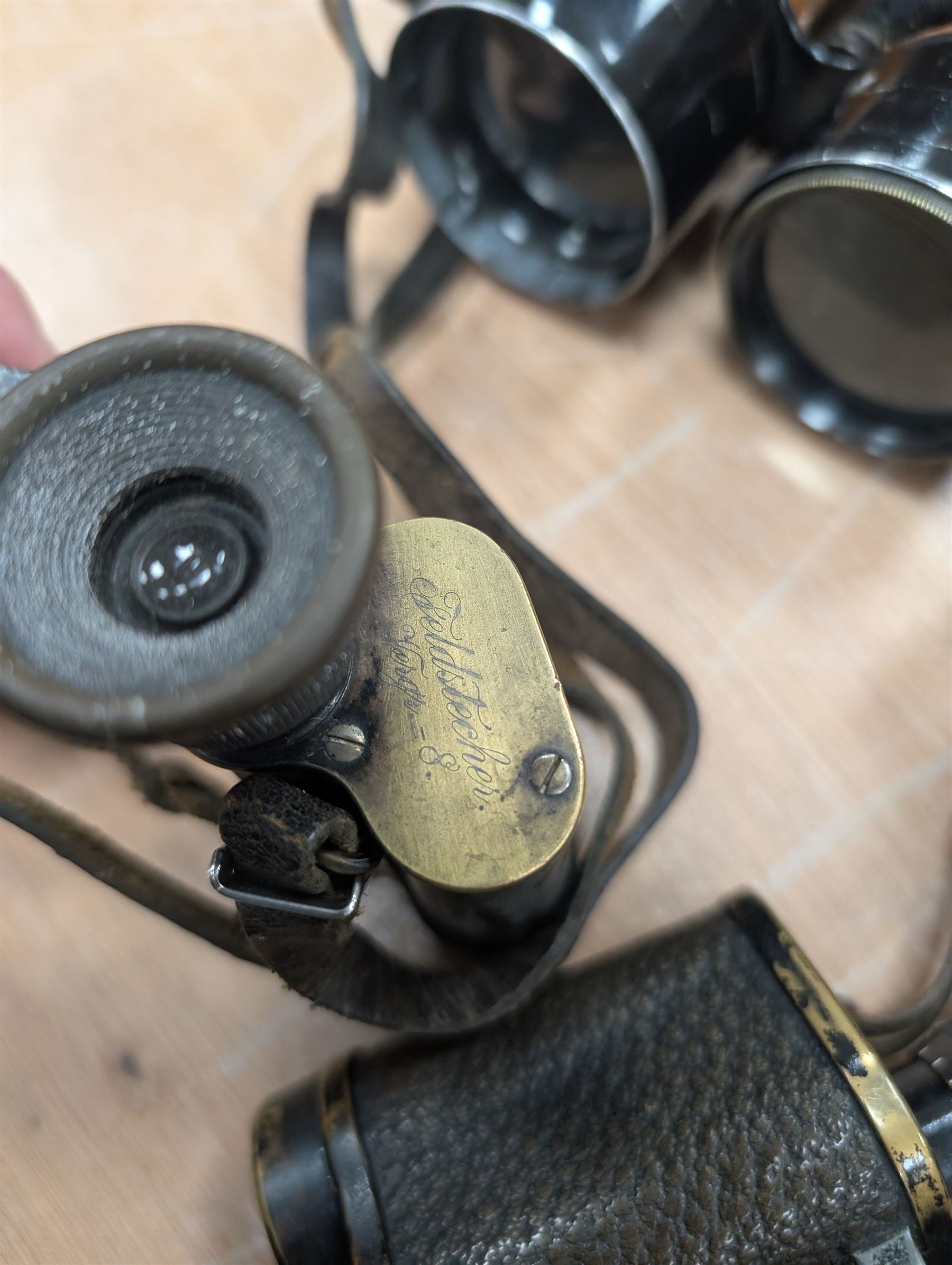 Four pairs of early 20th century binoculars, including Carl Zeiss Jena Feldstecher binoculars, Carl Zeiss Telact 8x binoculars, Dollond x5 field binolculars and one other pair, all in leather cases, one case marked with broad arrow, some with officers name etched